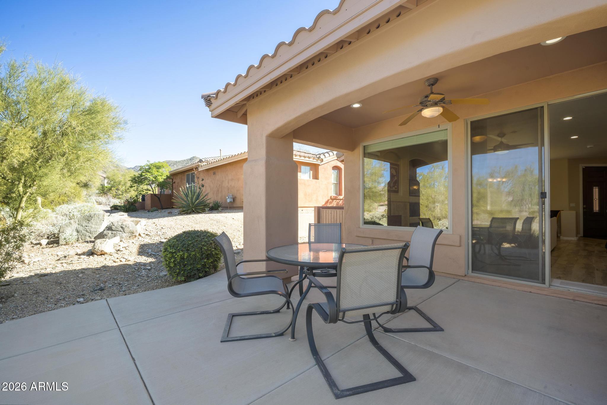 11448 East Raintree Drive Scottsdale, AZ 85255 - Photo 17 of 37 a patio with yard glass top table and chairs