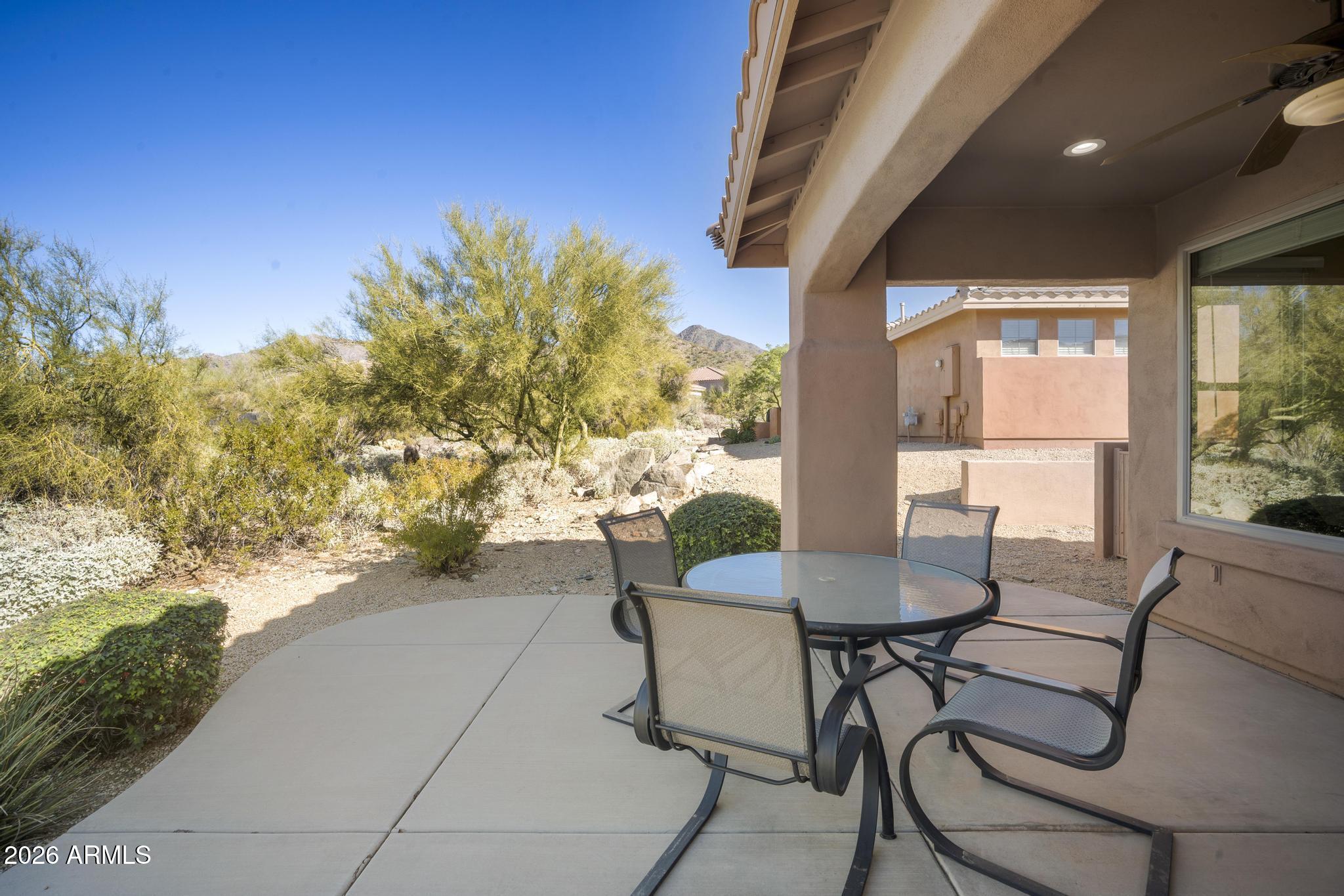 11448 East Raintree Drive Scottsdale, AZ 85255 - Photo 19 of 37 a view of a patio with table and chairs and potted plants