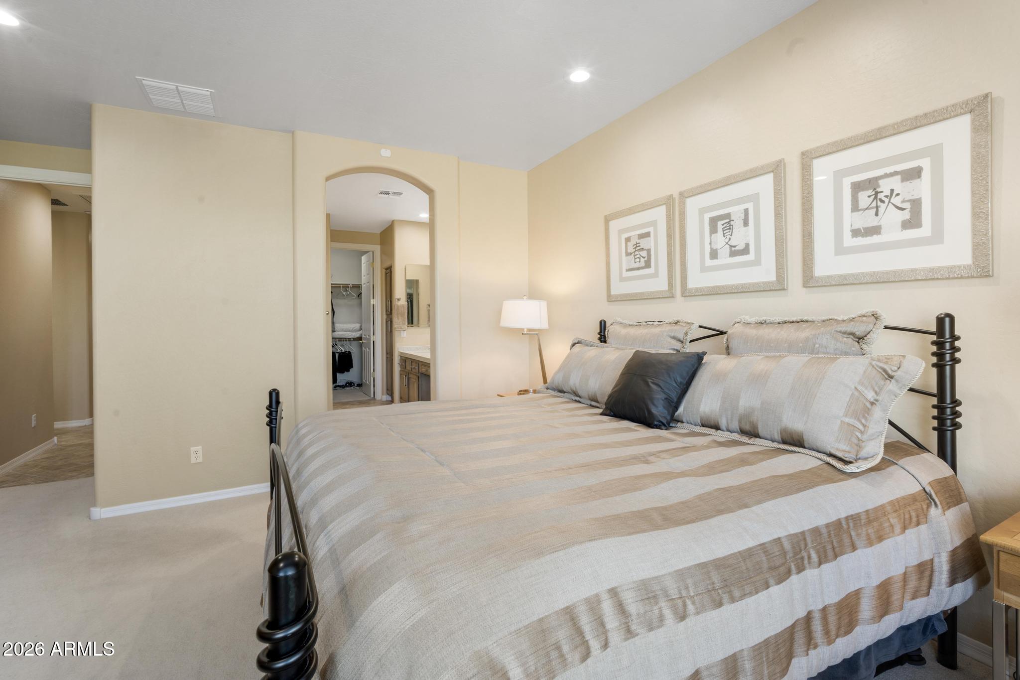 11448 East Raintree Drive Scottsdale, AZ 85255 - Photo 21 of 37 a bedroom with a large bed and a painting on the wall