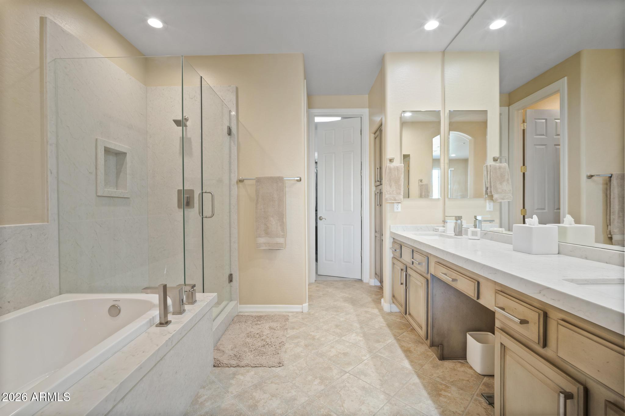 11448 East Raintree Drive Scottsdale, AZ 85255 - Photo 22 of 37 a spacious bathroom with a granite countertop sink a mirror a shower and a bathtub