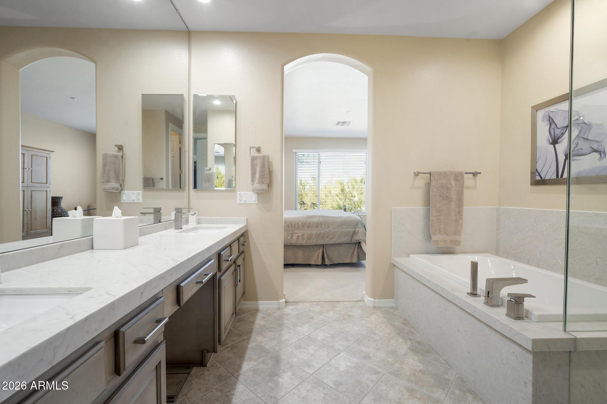 11448 East Raintree Drive Scottsdale, AZ 85255 - Photo 24 of 37 a spacious bathroom with a tub sink and mirror