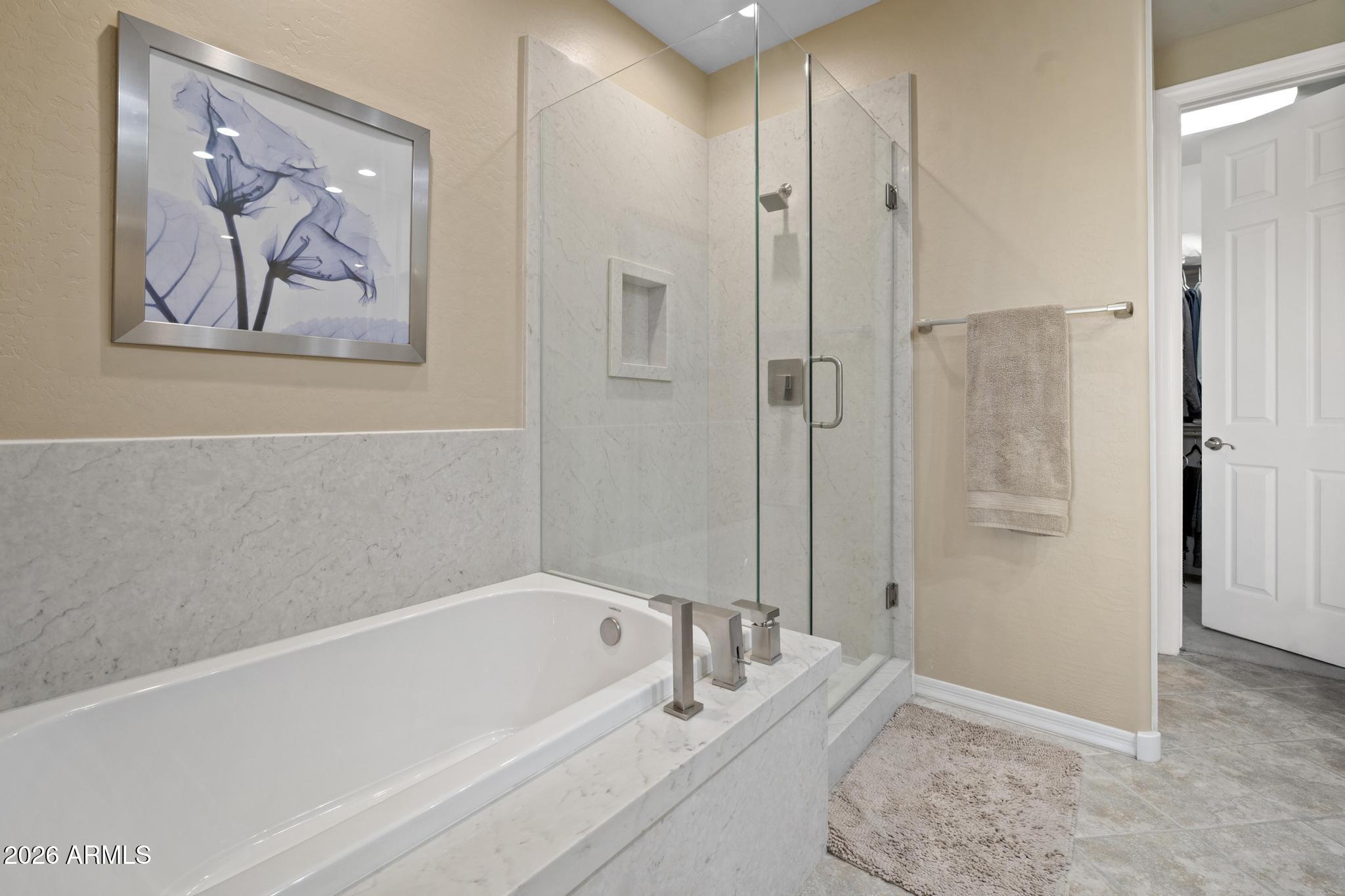 11448 East Raintree Drive Scottsdale, AZ 85255 - Photo 26 of 37 a spacious bathroom with a bathtub and a shower