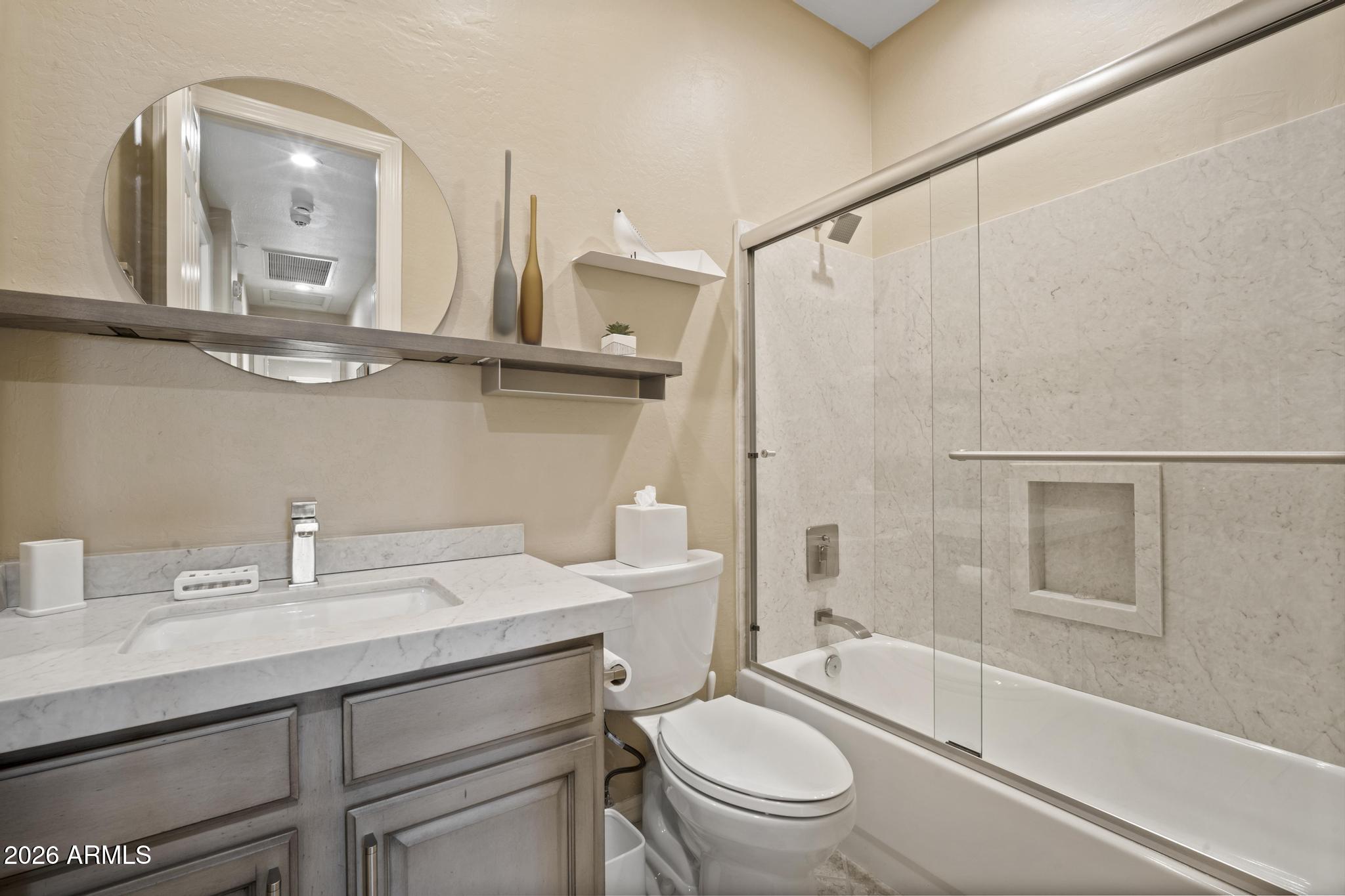 11448 East Raintree Drive Scottsdale, AZ 85255 - Photo 28 of 37 a bathroom with a sink a toilet and a mirror