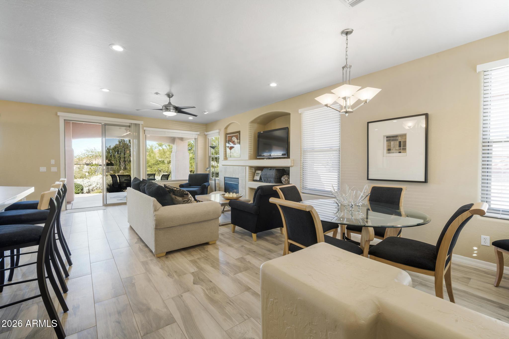 11448 East Raintree Drive Scottsdale, AZ 85255 - Photo 4 of 37 a living room with furniture chandelier and a flat screen tv