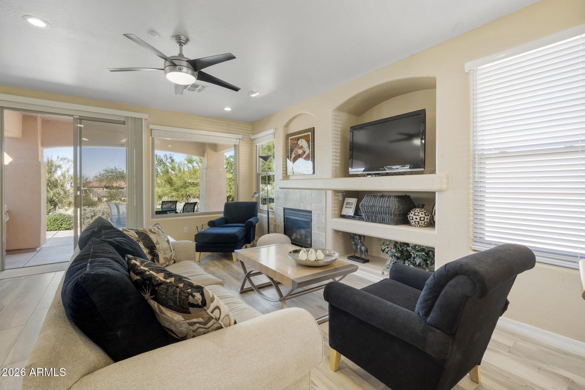 11448 East Raintree Drive Scottsdale, AZ 85255 - Photo 7 of 37 a living room with furniture fireplace and a flat screen tv