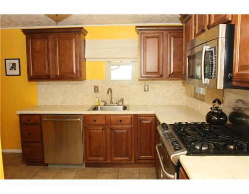 Kitchen. Kitchen Remodeled w/ Glazed Maple Cabinetry, crown moldings & ceramic counter top.