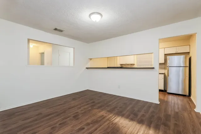 a view of a room with wooden floor and a window