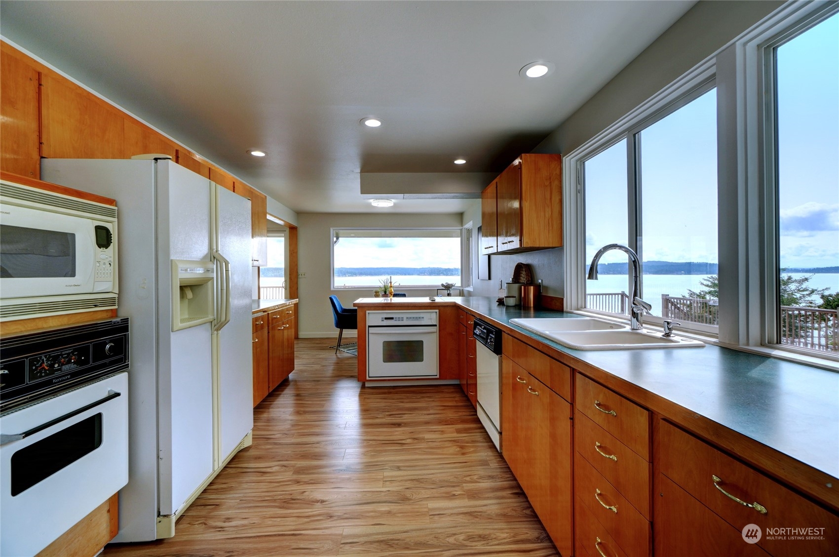 12922 Thomas Road Northwest Gig Harbor, WA 98329 - Photo 11 of 38 a large kitchen with stainless steel appliances a large window and a counter space