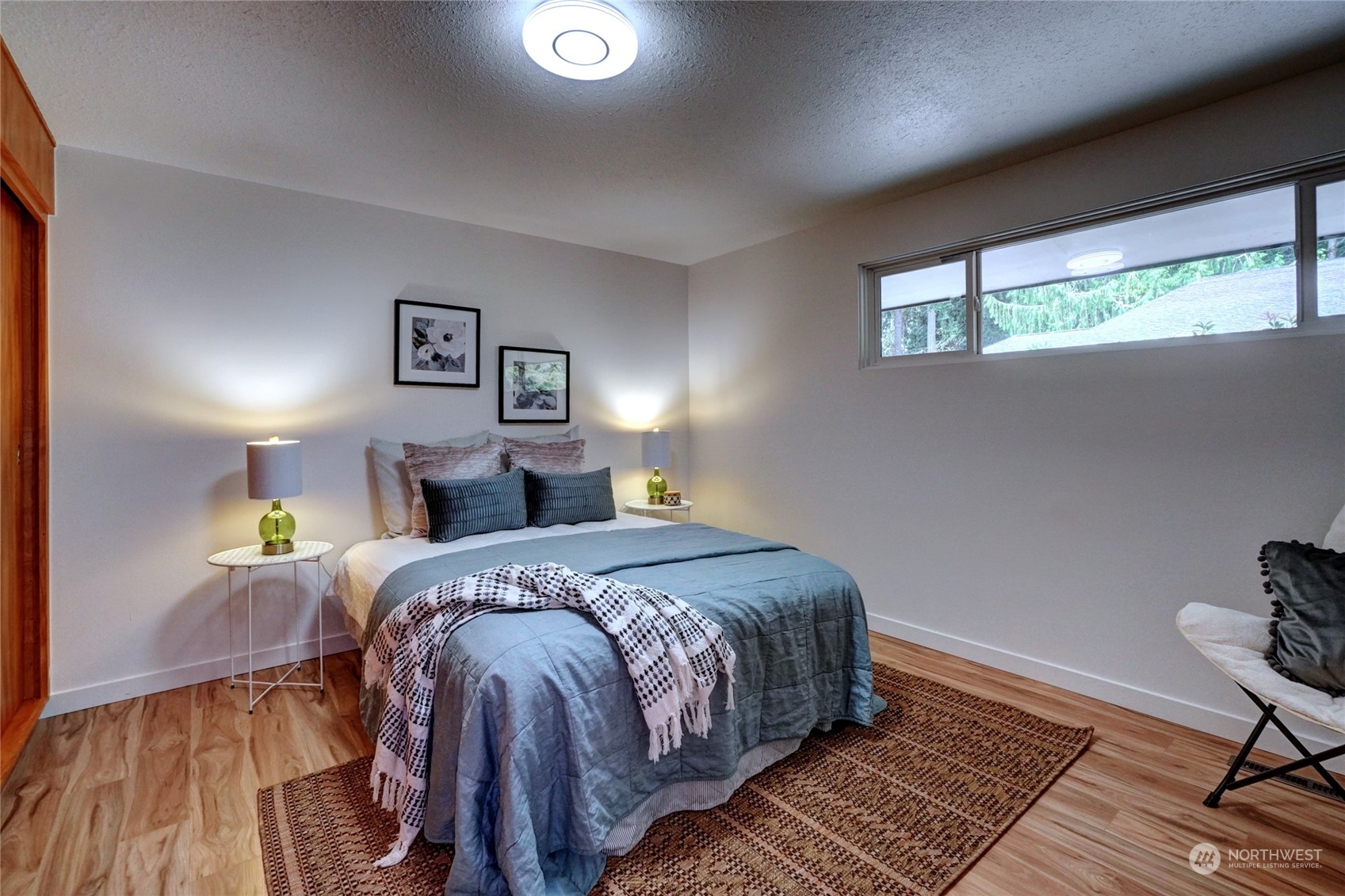 12922 Thomas Road Northwest Gig Harbor, WA 98329 - Photo 16 of 38 a bed room with a bed and a window