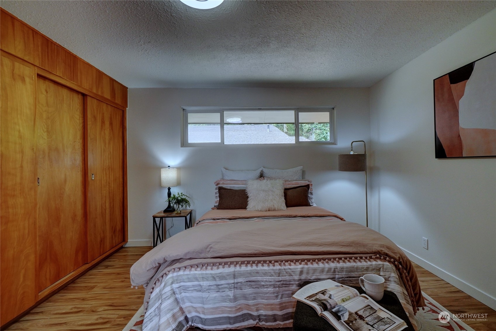 12922 Thomas Road Northwest Gig Harbor, WA 98329 - Photo 17 of 38 a bedroom with a bed and a tv on table