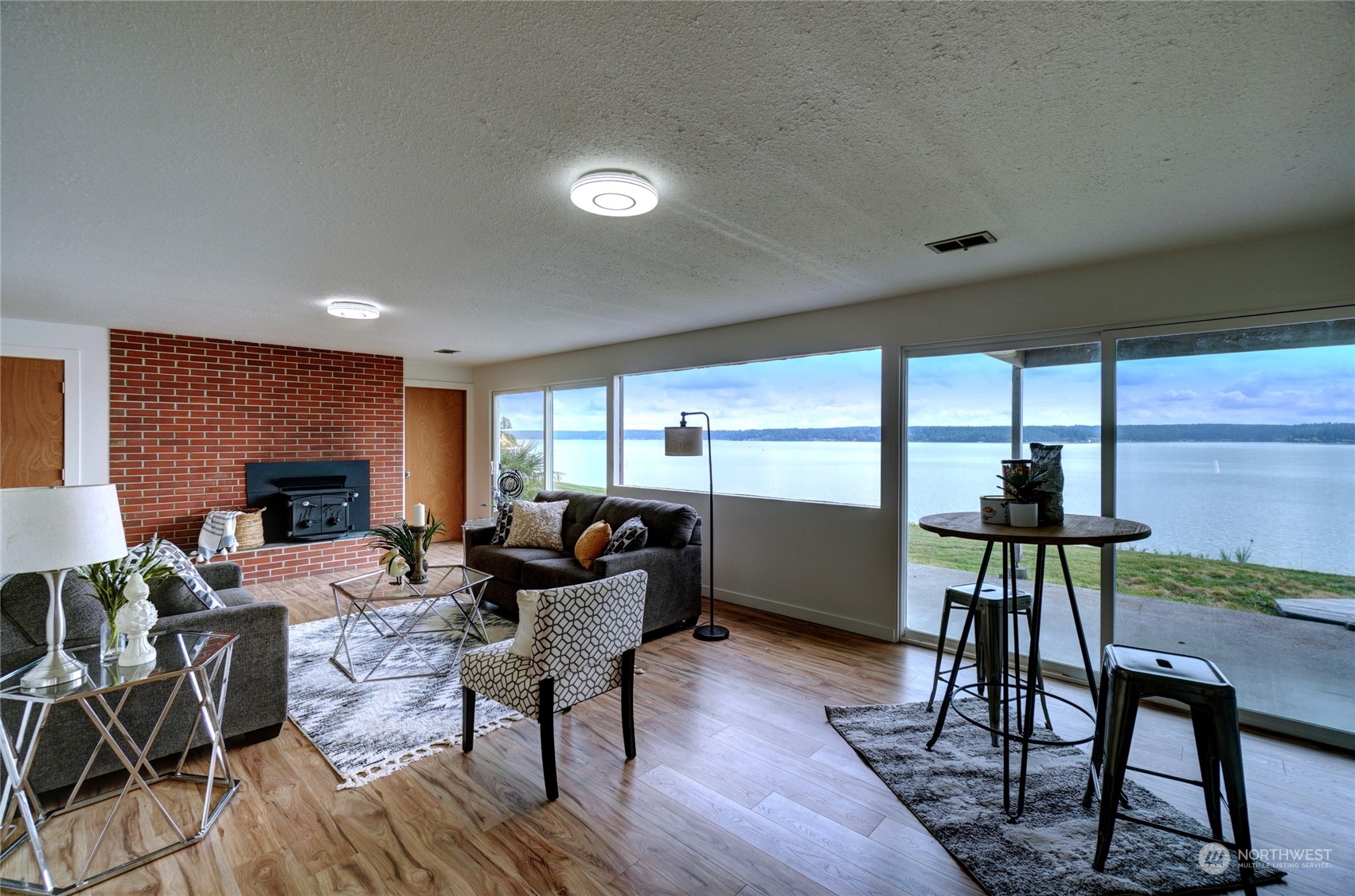 12922 Thomas Road Northwest Gig Harbor, WA 98329 - Photo 20 of 38 a living room with furniture a fireplace and a table