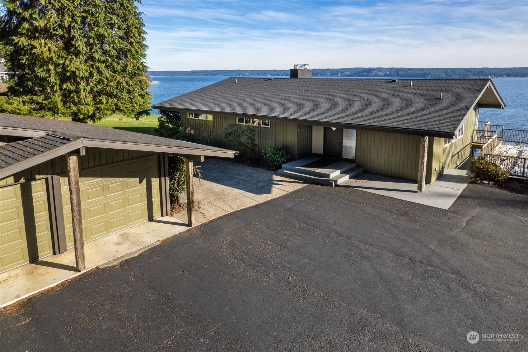 12922 Thomas Road Northwest Gig Harbor, WA 98329 - Photo 25 of 38 a view of a patio with table and chairs under an umbrella