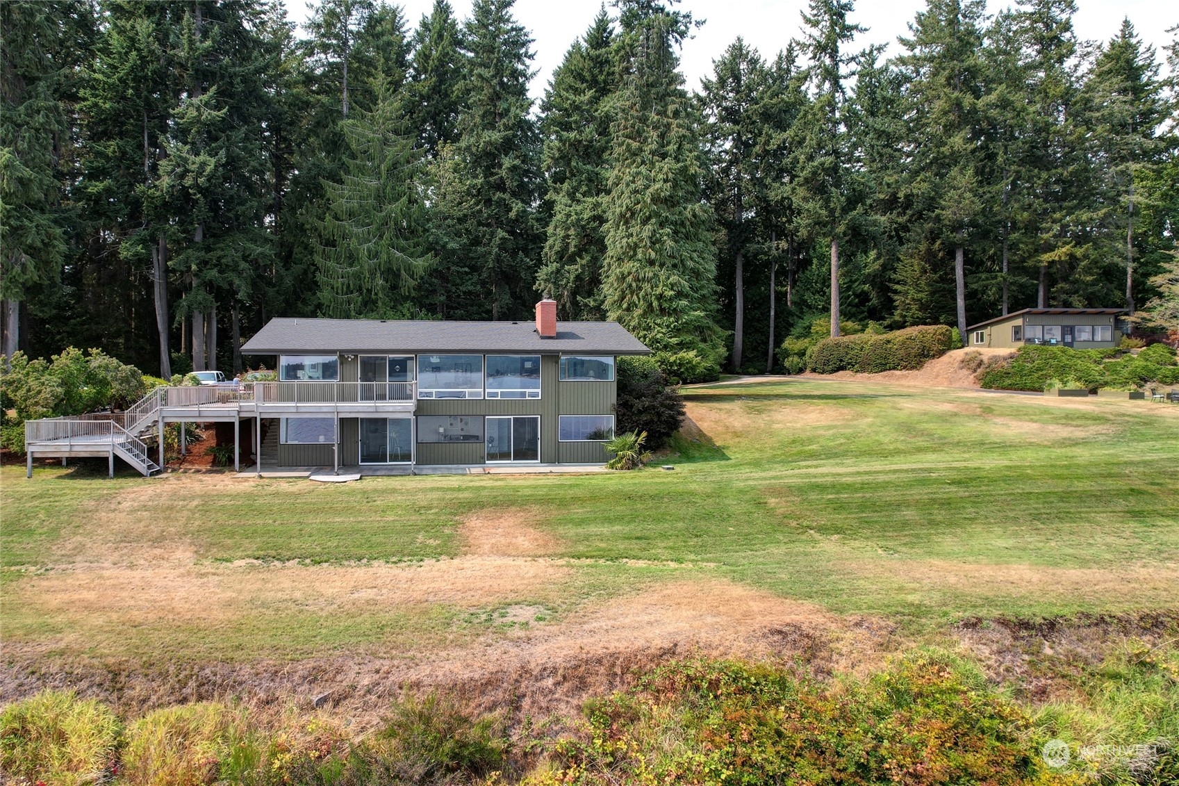 12922 Thomas Road Northwest Gig Harbor, WA 98329 - Photo 26 of 38 a view of a house with a big yard and large trees