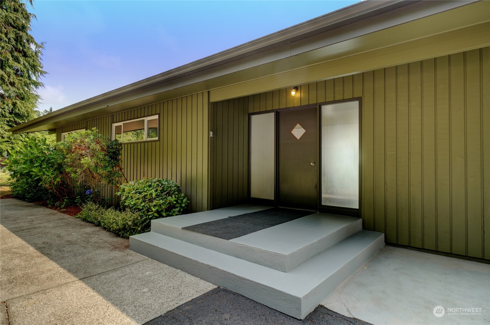 12922 Thomas Road Northwest Gig Harbor, WA 98329 - Photo 6 of 38 a front view of a house with a garden