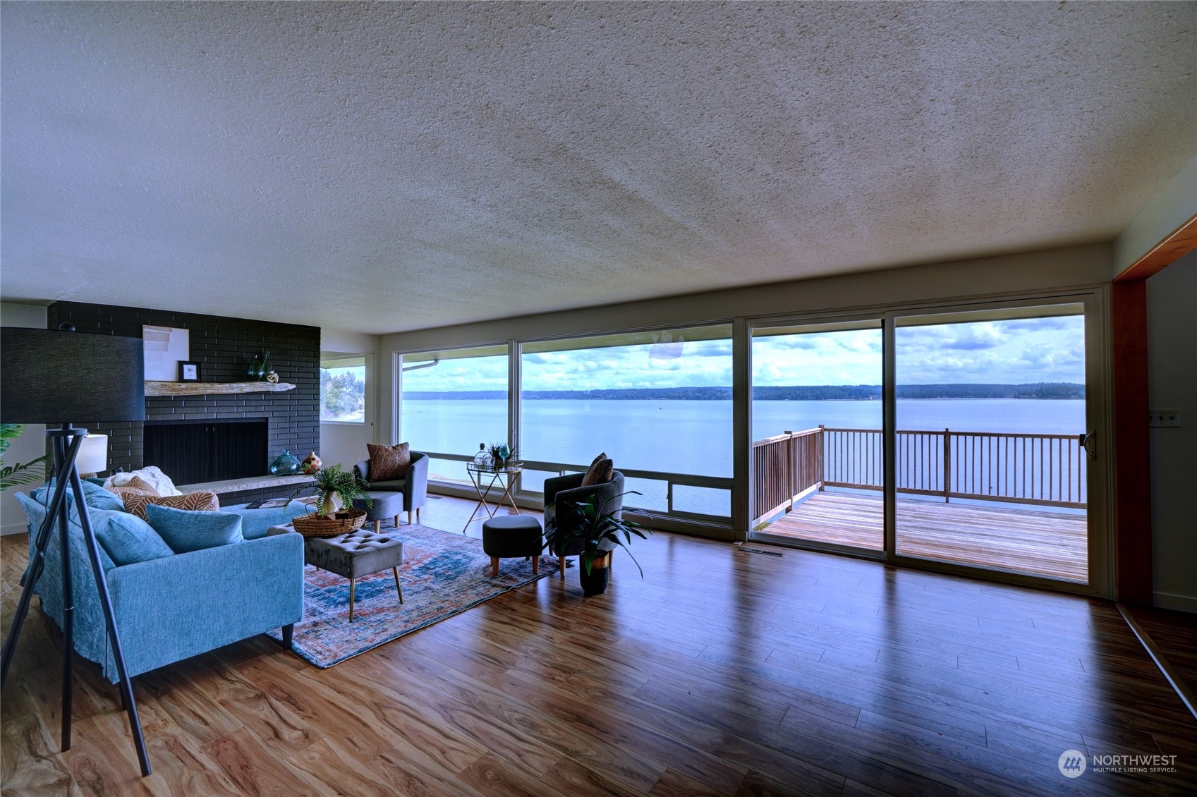 12922 Thomas Road Northwest Gig Harbor, WA 98329 - Photo 10 of 38 a living room with furniture and a fireplace
