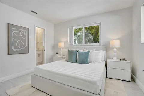 a bedroom with a large bed and a couch