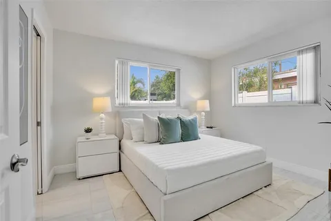a large white bed in a white room