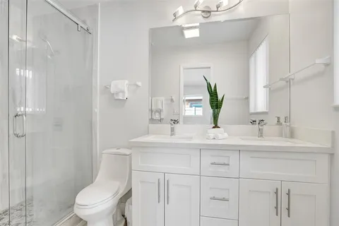 a bathroom with a toilet a sink and mirror