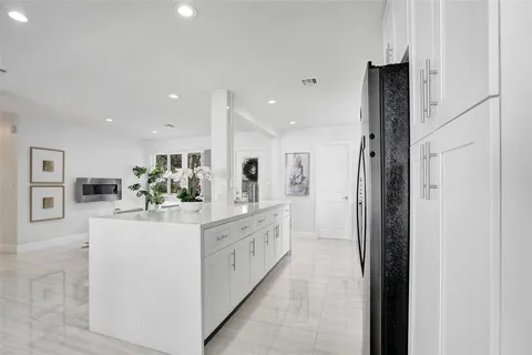 a kitchen with stainless steel appliances kitchen island sink refrigerator and stove