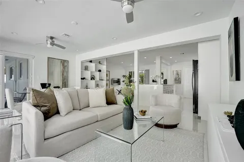 a living room with furniture and a large mirror