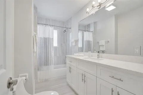 a bathroom with a sink a mirror and a shower