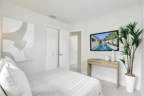 a bedroom with a bed and a painting on the wall