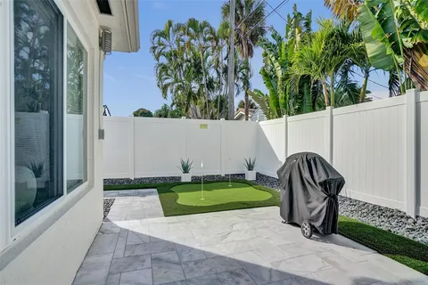 a view of a back yard of the house and a patio