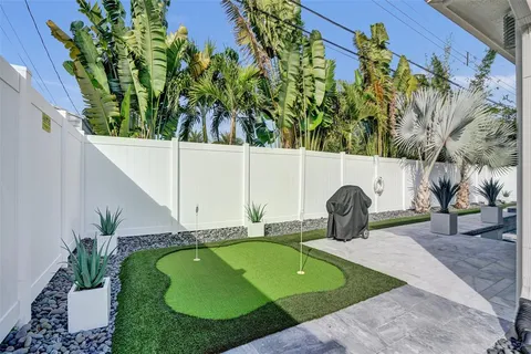 a view of a backyard with plants and outdoor seating