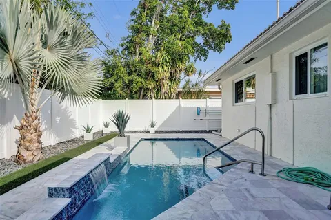 a view of swimming pool with a patio and a yard