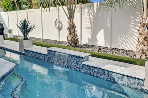 a view of a swimming pool with a table and chairs