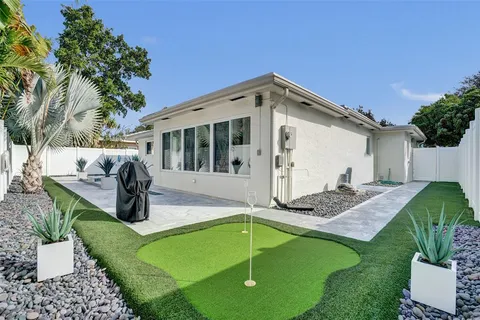 a view of house with backyard outdoor seating and green space