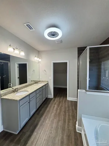 a large bathroom with a large mirror vanity and sink