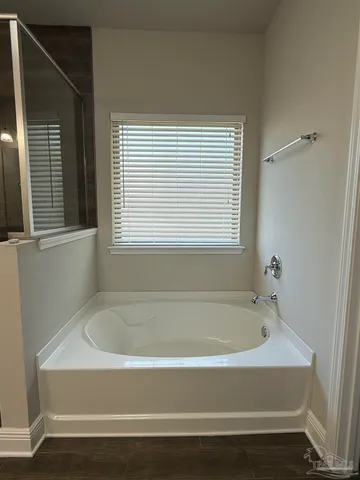 a white bath tub sitting next to a window