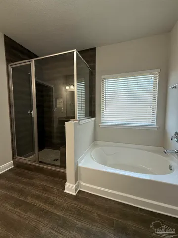 a bathroom with a tub and shower
