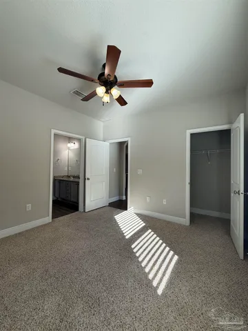 a view of an empty room with a ceiling fan