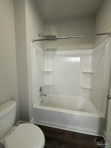 a bathroom with a toilet and a bathtub