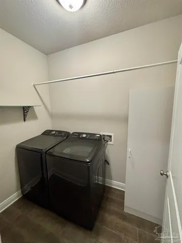 a view of empty room with stairs and mirrors