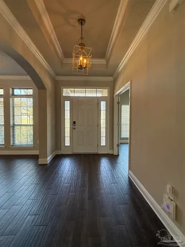 a view of a room with wooden floors and chandelier