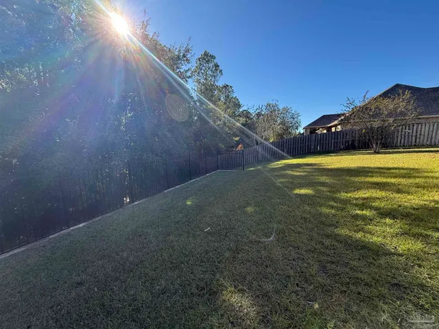 a backyard of a house with lots of green space