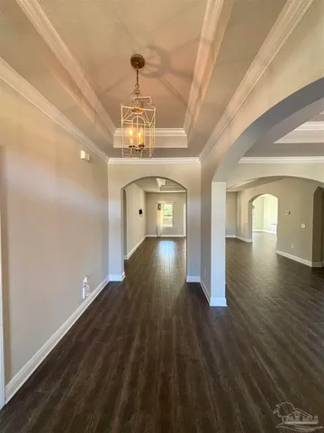 a view of a room with wooden floor staircase and a kitchen