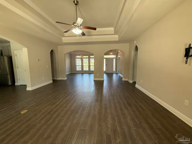 a view of a room with wooden floor