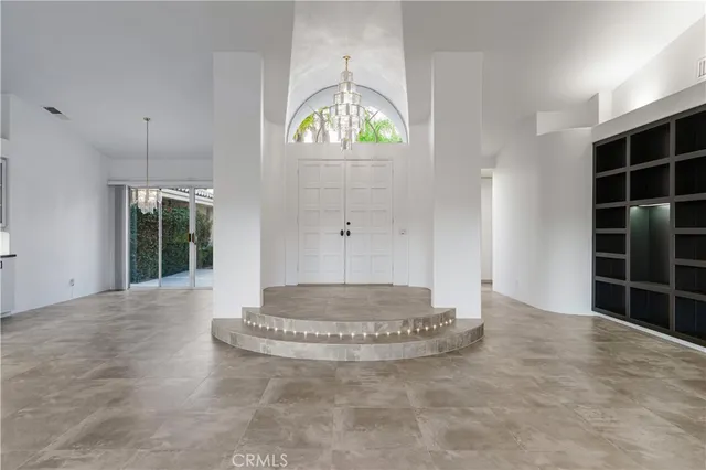 a view of an empty room with glass door and balcony