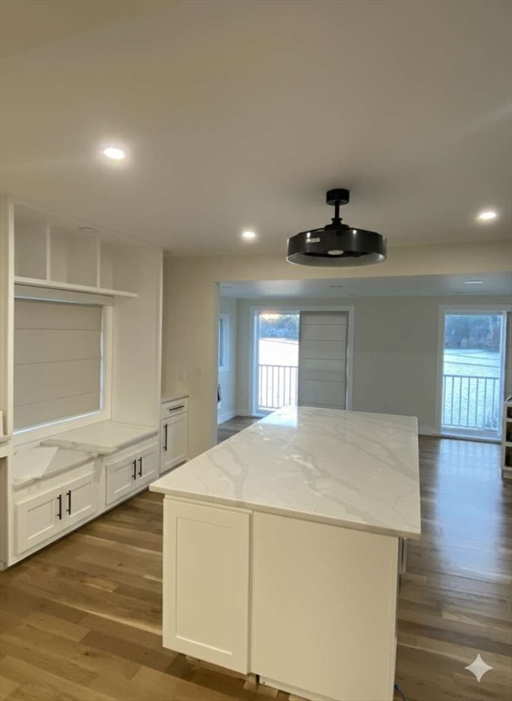 30 Russell Road, Unit 30 Chelmsford, MA 01863 - Photo 11 of 20 a kitchen with kitchen island a stove a sink and white cabinets