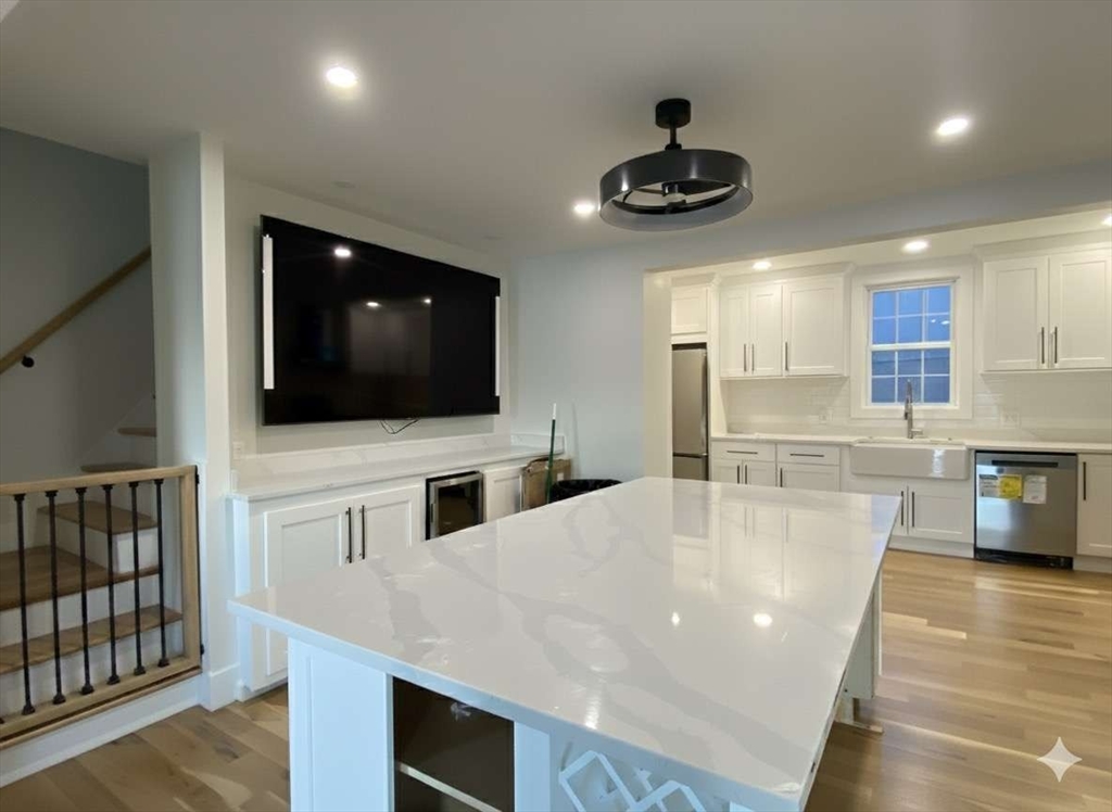 30 Russell Road, Unit 30 Chelmsford, MA 01863 - Photo 12 of 20 a kitchen with stainless steel appliances a microwave a stove and a microwave