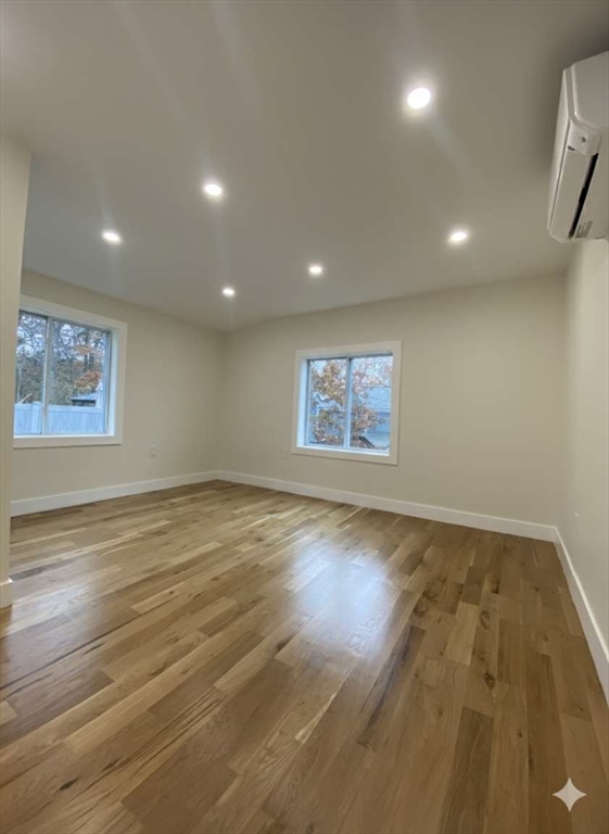 30 Russell Road, Unit 30 Chelmsford, MA 01863 - Photo 15 of 20 an empty room with wooden floor and windows
