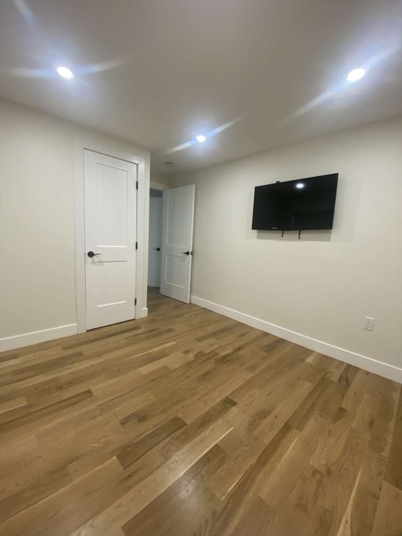 30 Russell Road, Unit 30 Chelmsford, MA 01863 - Photo 16 of 20 an empty room with kitchen view and a flat screen tv