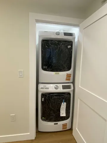 a kitchen with granite countertop a sink stove and refrigerator