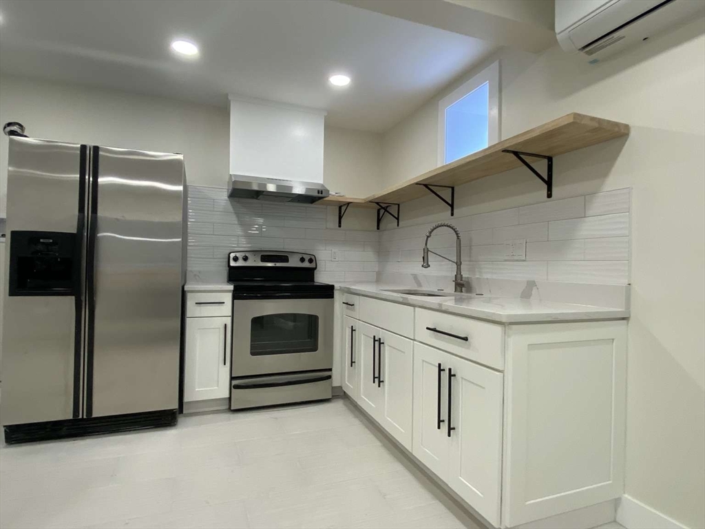 30 Russell Road, Unit 30 Chelmsford, MA 01863 - Photo 18 of 20 a kitchen with granite countertop a sink stove and refrigerator