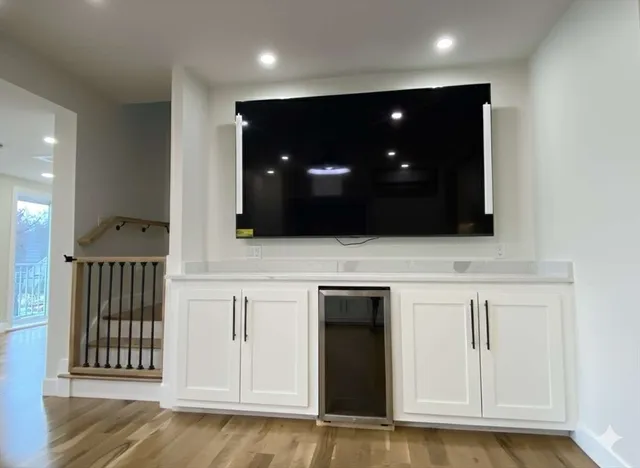 a view of an empty room with wooden floor