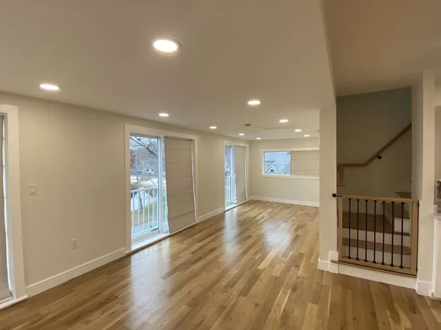 a view of kitchen with wooden floor and cabinets